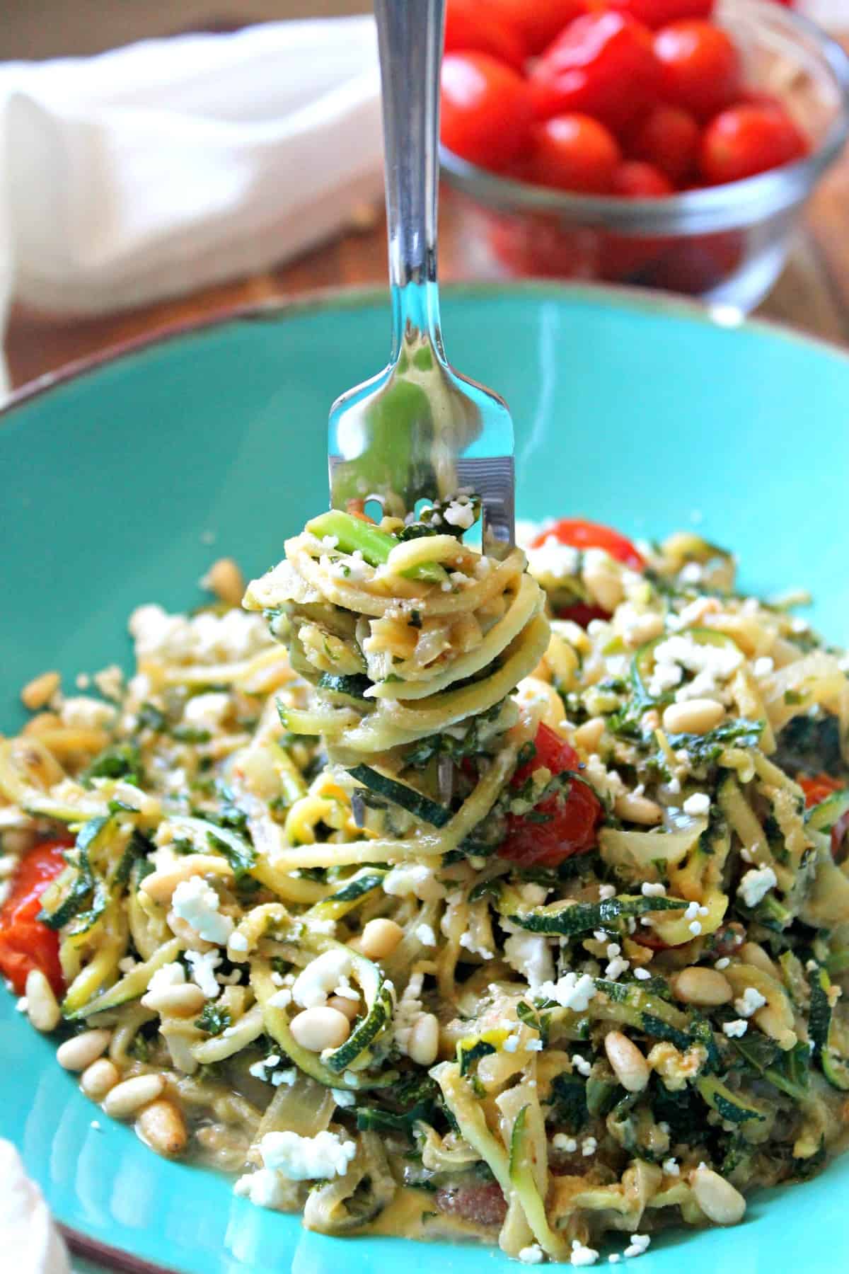 Guilt-free Zucchini pasta with kale, onions, goat cheese, and juicy roasted tomatoes