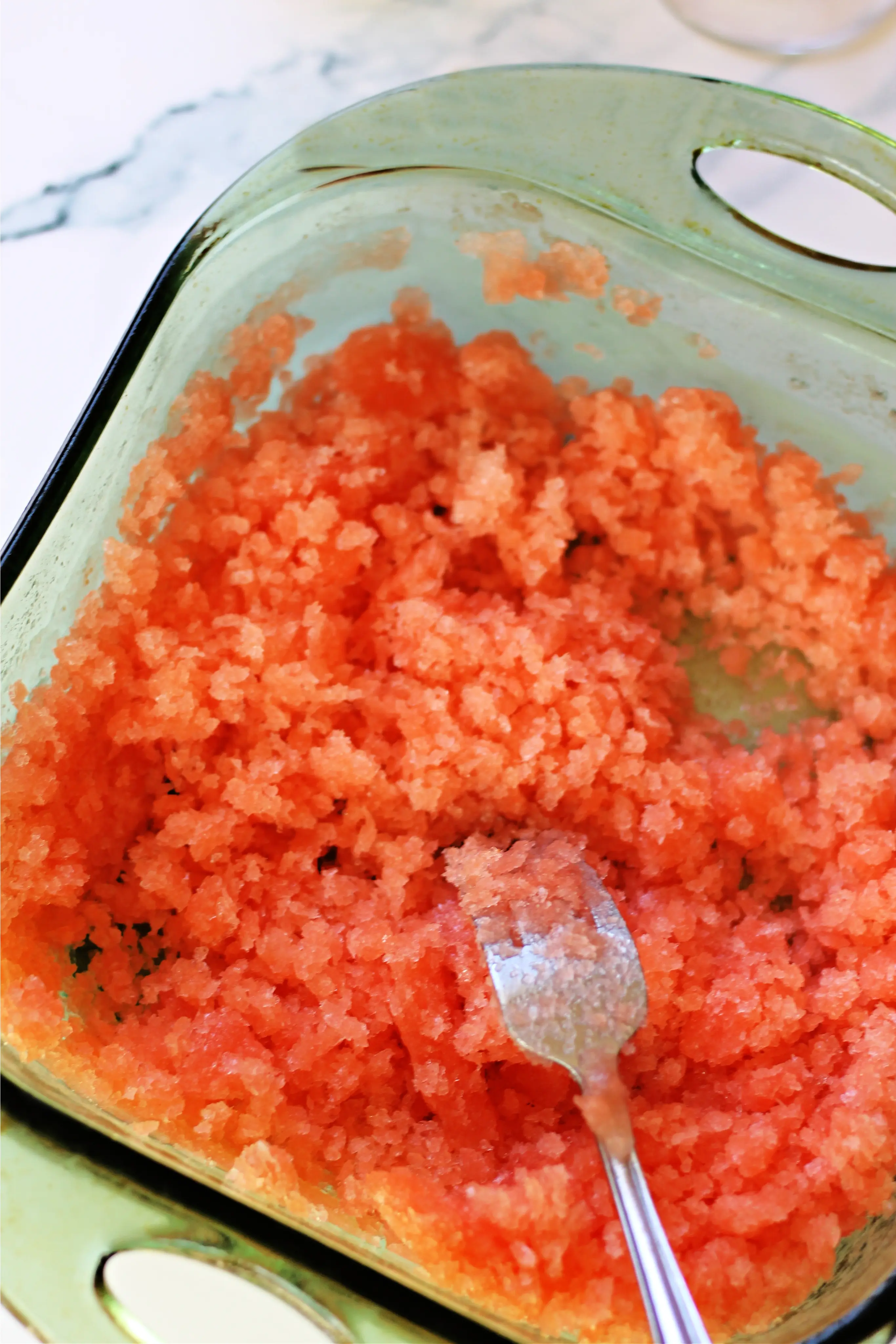 Process shot of scraping granita into ice crystals.