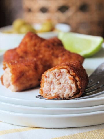 Close up showing interior of Croqueta de Jamon on a white plate.