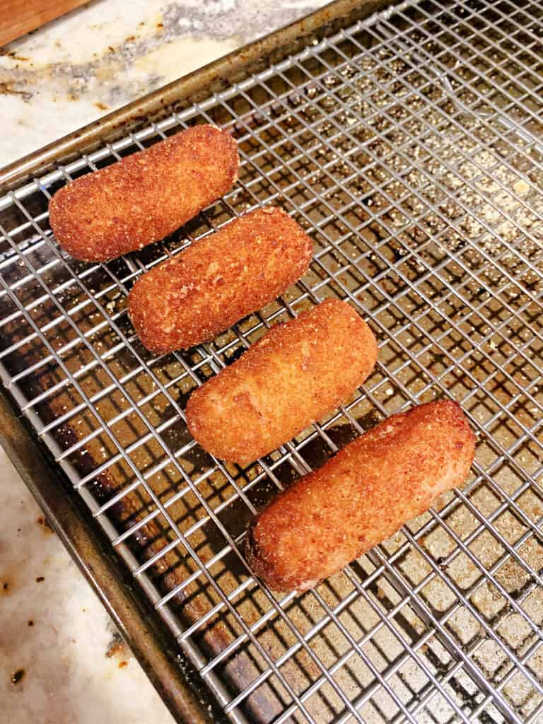 Fried Croquetas de Jamon on a cooling rack.