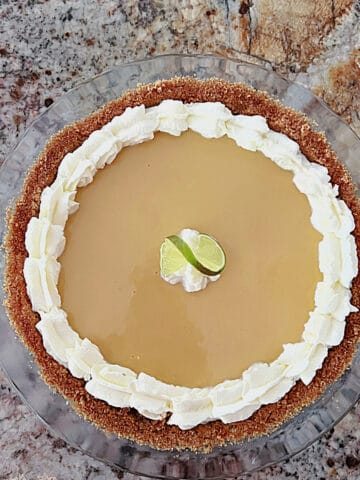 An overhead shot of Key West Key Lime Pie with whipped cream topping.