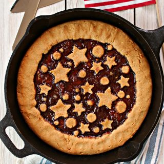 Strawberry-Peanut Butter Tart! If you're looking for easy peanut butter dessert recipes, look no further! This All-American tart boasts the flavors of a classic PB & J in tart form! A great take-along for summer potlucks, Memorial Day and the 4th of July. 