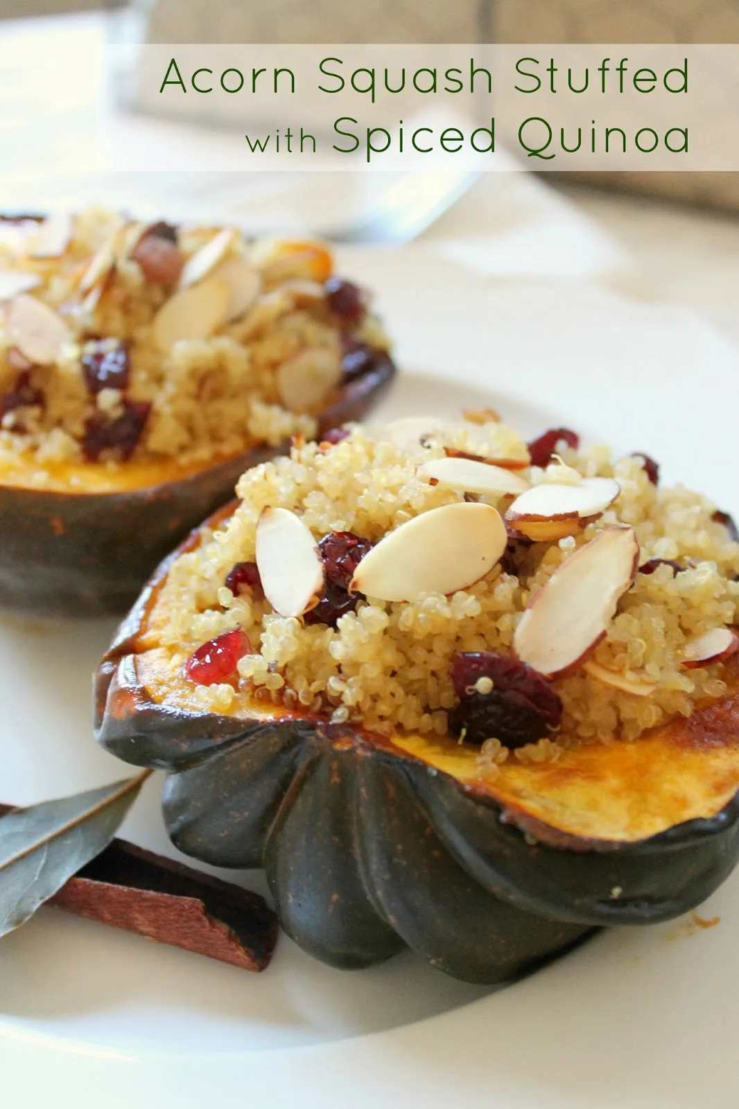 Close up of stuffed acorn squash with bay leaves.