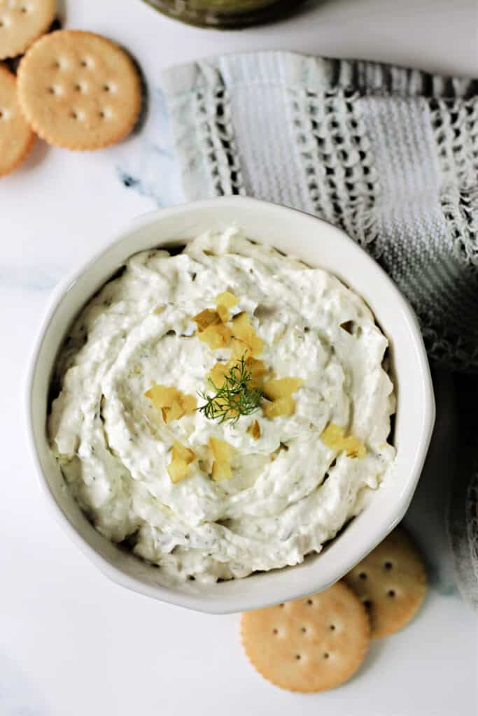 Close up of Dill Pickle Dip in a white bowl to show texture.