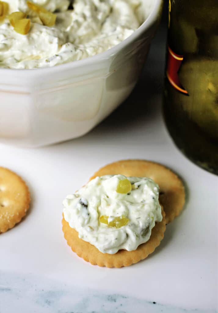 Dill Pickle Dip spread onto a cracker.