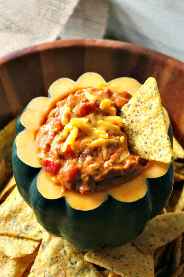 Close up of Pumpkin Chili Cheese Dip in a hollowed out acorn squash.