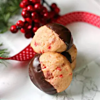 Close up of chocolate dipped Maraschino Cherry Cookies on marble counter.