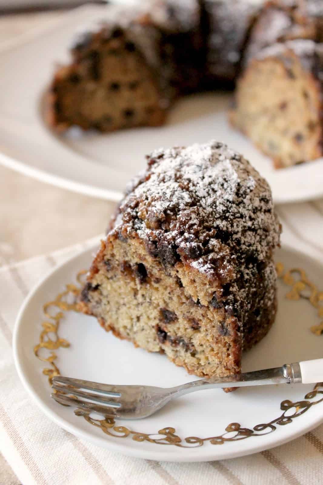 A slice of Chocolate Chip Banana Bundt Cake on a small plate with a fork.