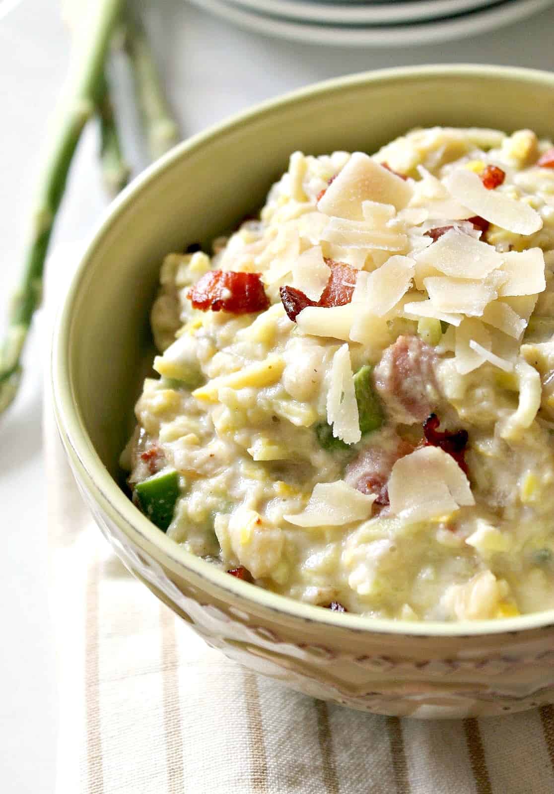 Bacon & Asparagus "Risotto"! This may be "faux-sotto", but the flavor is REAL in this vegetable risotto -- made with spiralized summer squash and a creamy caulflower cheese sauce, this dish is loaded with veggies and springtime flavors that will keep you coming back for more. 