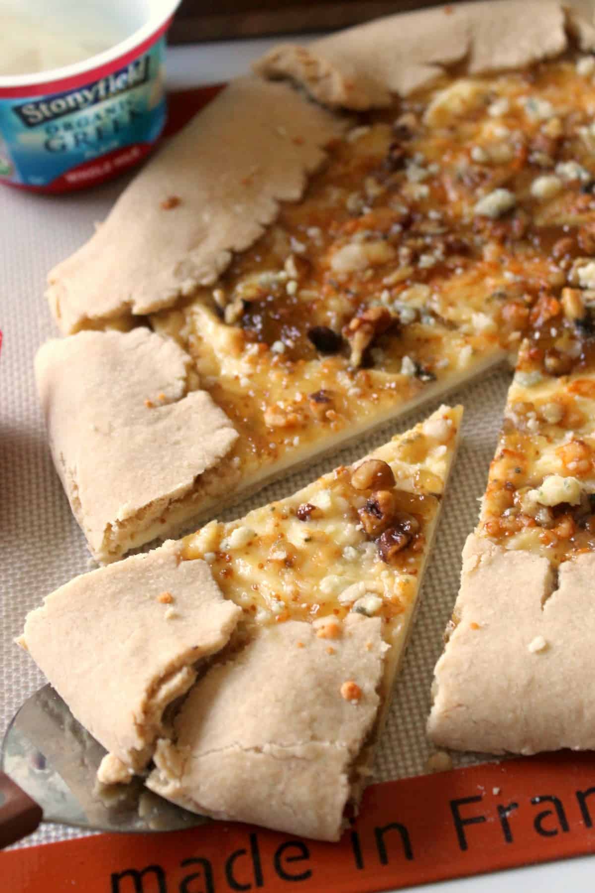 Gorgonzola & Fig Jam Crostata. A tender, rustic tart slathered with a creamy filling and fig jam swirl, topped with savory Gorgonzola cheese and walnuts.