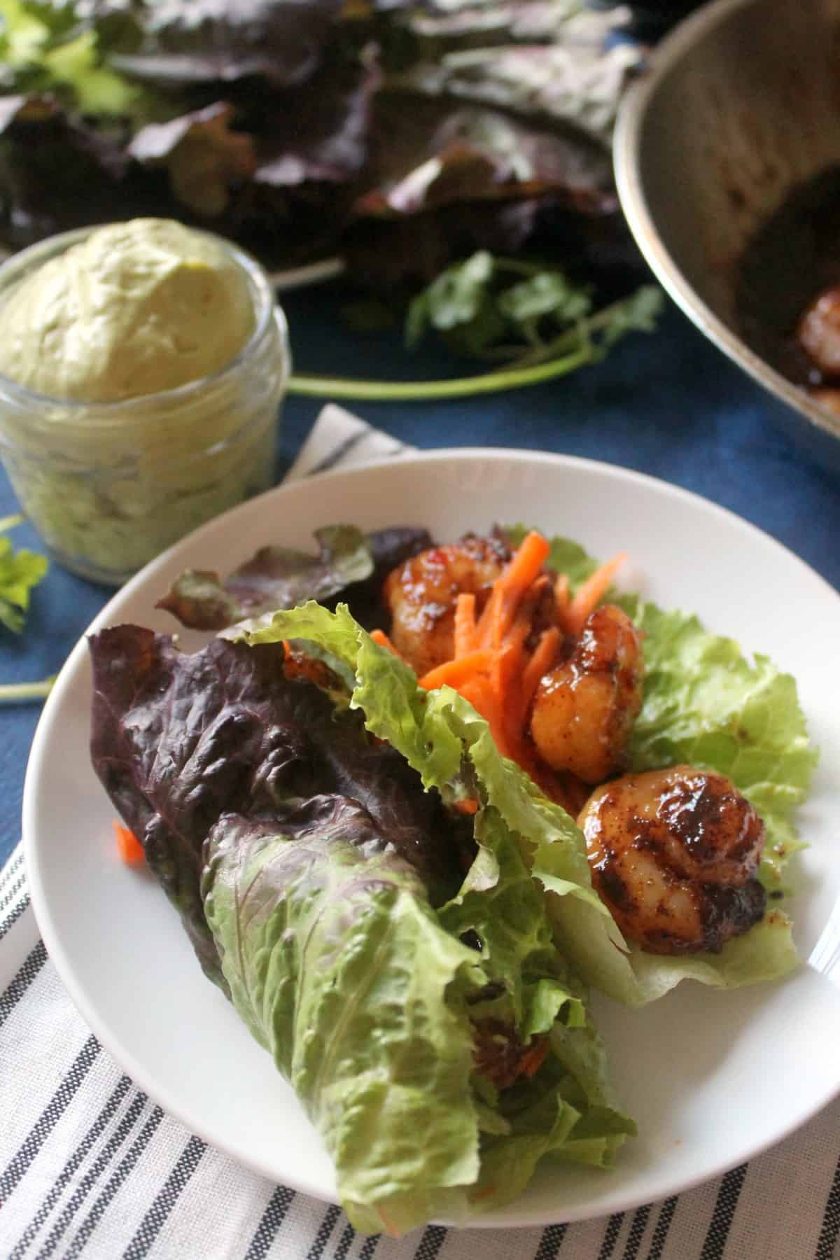 Sweet & Spicy Shrimp Lettuce Wraps with Avocado Cream! These satisfying wraps take just minutes to make but will leave you dreaming about them for days! 
