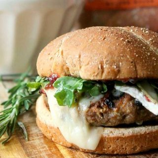 Grilled turkey burger with melted brie on burger bun.