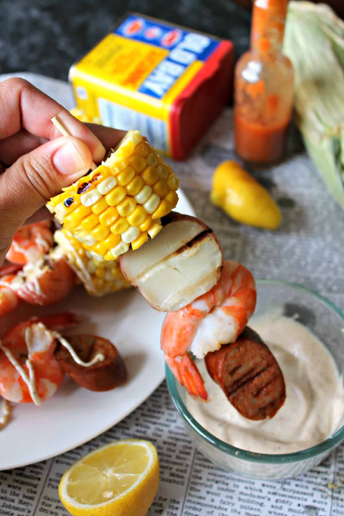 Shrimp Boil Kabobs are summer on a stick! Tender shrimp, corn, sausage, and potatoes drizzled with an Old Bay spice aioli
