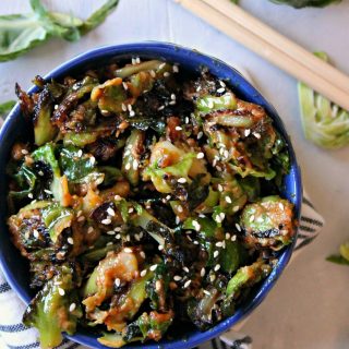 Sesame Peanut Brussels Sprouts! If you or your family need convincing that Brussels sprouts can be delicious, this recipe is the ticket to a clean plate! Savory peanut butter sauce with a dash of sweetness and a hint of spice glaze these sprouts for a side dish that will grace your table again and again. 