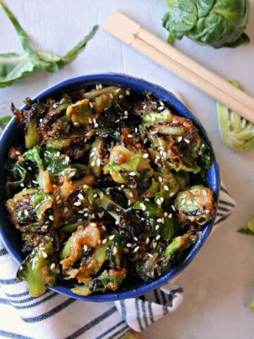 Sesame Peanut Brussels Sprouts! If you or your family need convincing that Brussels sprouts can be delicious, this recipe is the ticket to a clean plate! Savory peanut butter sauce with a dash of sweetness and a hint of spice glaze these sprouts for a side dish that will grace your table again and again. 