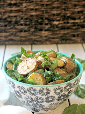Roasted Potato & Spinach Salad! No mayo here, just a bright and tangy vinaigrette that makes this simple potato salad equally scrumptious. Served warm or at room temperature, it's a versatile, crowd-pleasing side dish you'll make again and again.