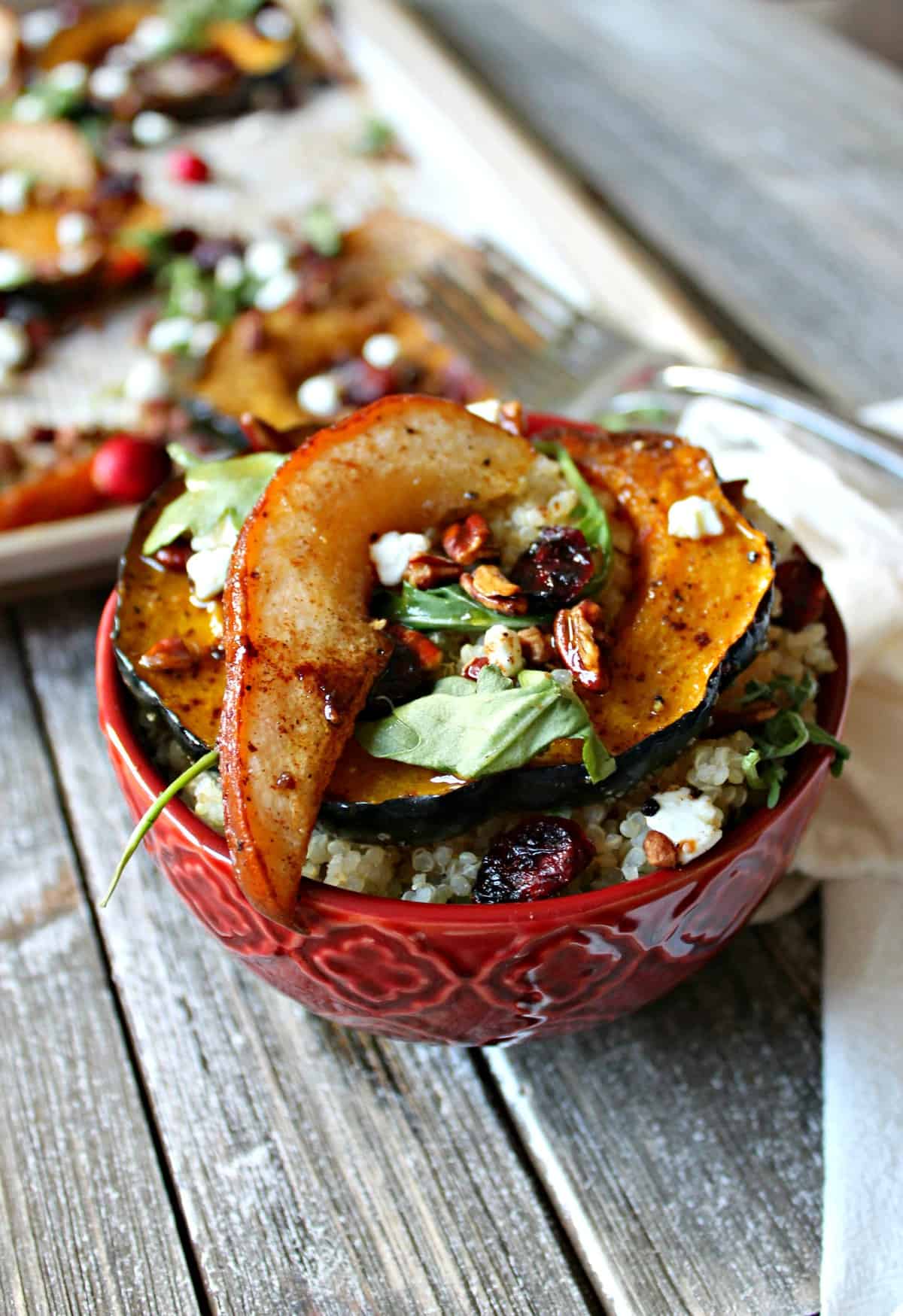Spiced acorn squash, pears and quinoa cook simultaneously in the oven before being tossed with dried cranberries, pecans, goat cheese, and fresh arugula.