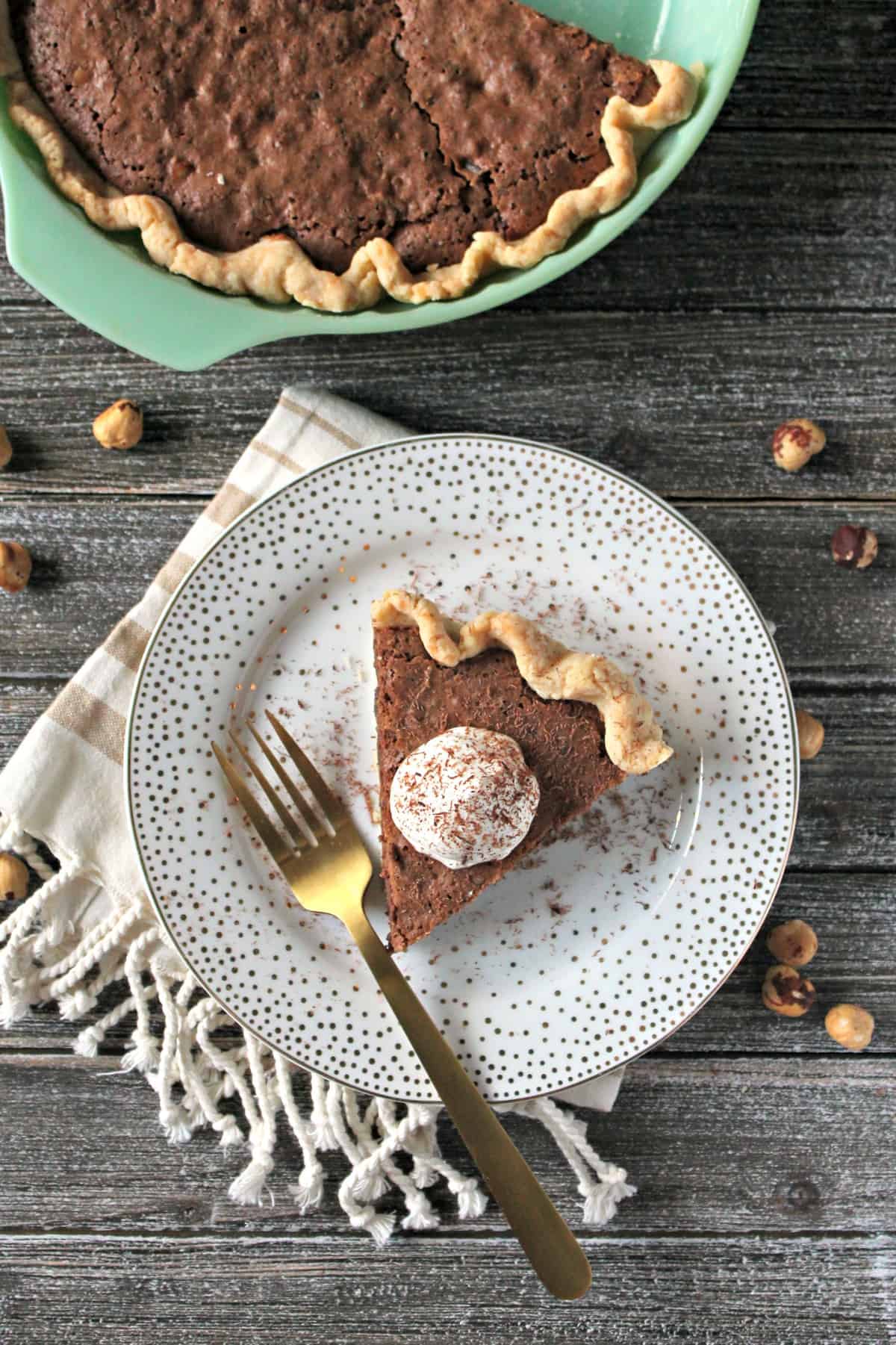 Hazelnut Chocolate Chunk Pie with Yogurt Whipped Cream! Not a fan of traditional pies? This fudgey version is filled with chocolate chunks & hazelnuts!