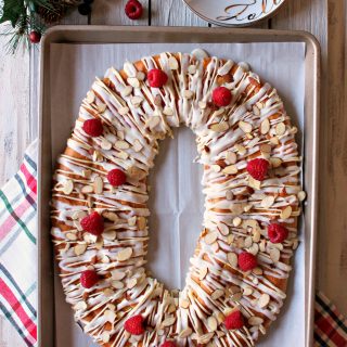 Raspberry White Chocolate Almond Kringle! Beautiful pastry studded with fresh raspberries, sweet drizzle & crunchy almonds. A perfect holiday breakfast.