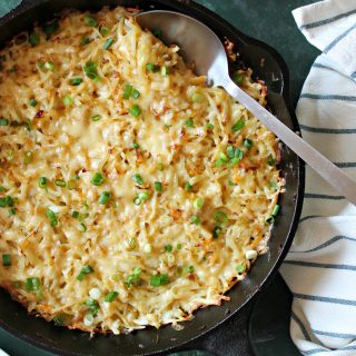 Irish Cheddar & Cabbage Hash Brown Skillet! You can't go wrong with cheesy hash brown potatoes and savory cabbage baked until golden and bubbly. A great side dish for St. Patrick's Day!