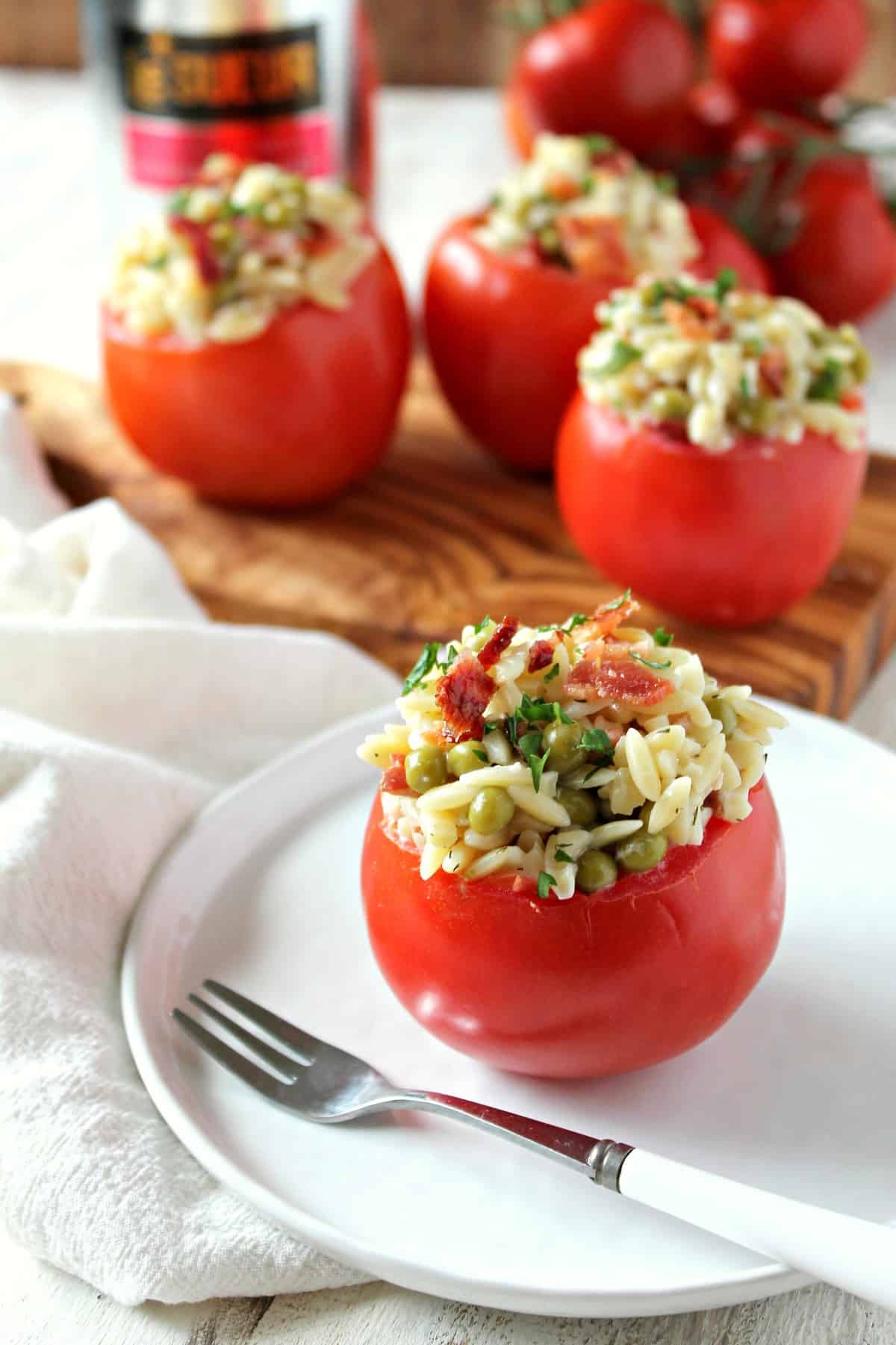 "BLP" Stuffed Tomatoes! A twist on the BLT sandwich, these stuffed tomatoes have the addition of pasta and peas to give them a pop of springtime flavor. Great for an Easter brunch or any spring occasion.