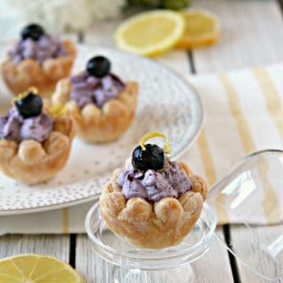 Blueberry Lemon Puff Pastry Blossoms! A sweet spring treat, these pretty little bites are made with store bought puff pastry and filled with a heavenly blueberry-lemon cream. A great addition to brunches, showers and tea parties.