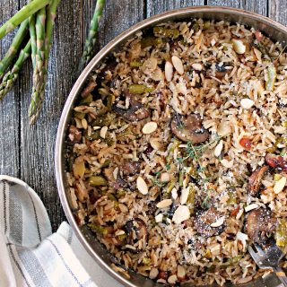 Baked Parmesan, Asparagus & Mushroom Rice Pilaf. This savory side dish starts on the stove top, then bakes to perfection in the oven, resulting in perfect rice every time. A great complement to spring meals!