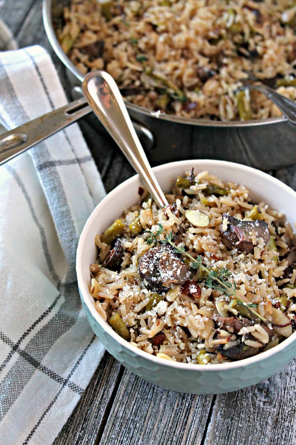 Baked Parmesan, Asparagus & Mushroom Rice Pilaf. This savory side dish starts on the stove top, then bakes to perfection in the oven, resulting in perfect rice every time. A great complement to spring meals!
