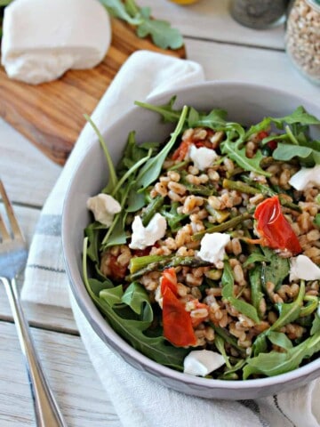 Springtime Farro Salad with Burrata! This simple spring salad is bursting with fresh flavors from seasonal vegetables to a zesty vinaigrette. Creamy burrata elevates it to a salad worth serving to company.