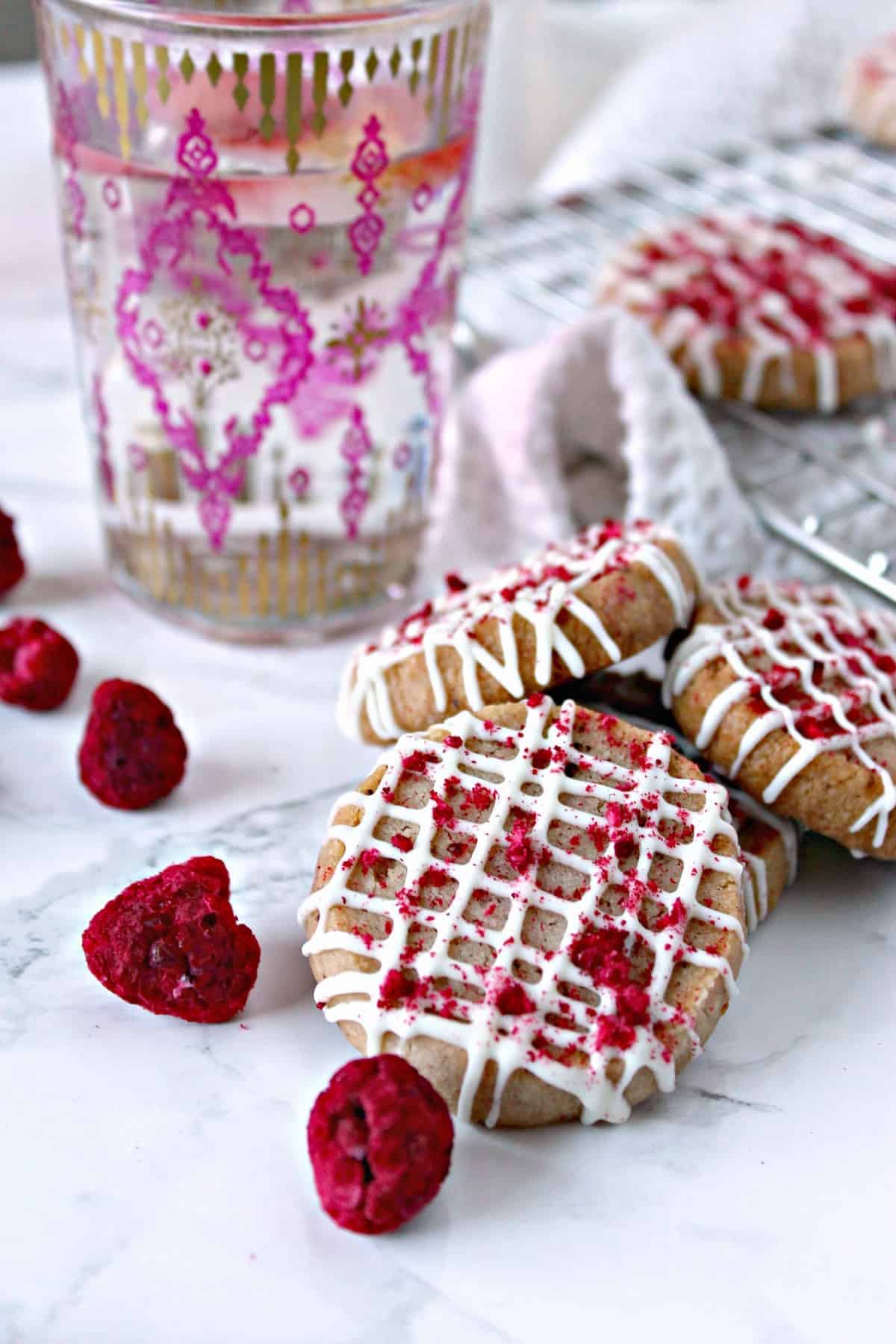 Raspberry Shortbread with White Chocolate Drizzle! Buttery, melt-in-your-mouth cookies with a hint of raspberry flavor, these tender cookies make a wonderful tea time treat.