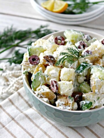 Tzatziki Potato Salad with Kalamata Olives! A fresh, lighter take on a summer favorite, this potato salad features flavors found in tzatziki, a Mediterranean yogurt-based sauce that's often served as a dip or in accompaniment to grilled meats. Salty Kalamata olives and feta cheese give the classic summertime side dish a new spin that will keep everyone coming back for more. 