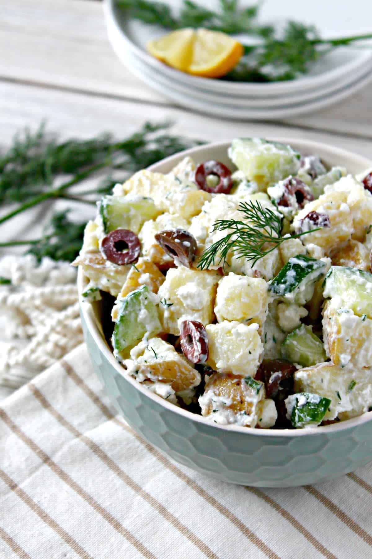 Tzatziki Potato Salad with Kalamata Olives! A fresh, lighter take on a summer favorite, this potato salad features flavors found in tzatziki, a Mediterranean yogurt-based sauce that's often served as a dip or in accompaniment to grilled meats. Salty Kalamata olives and feta cheese give the classic summertime side dish a new spin that will keep everyone coming back for more. 