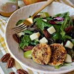 Autumn Harvest Salad with Pecan-Crusted Warm Goat Cheese Medallions! Fresh greens topped with apples, cranberries & baked goat cheese encrusted with pecans come together in the best autumn salad ever! 
