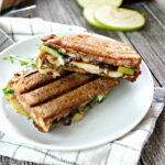 Apple Grilled Cheese with fig jam on a white plate.