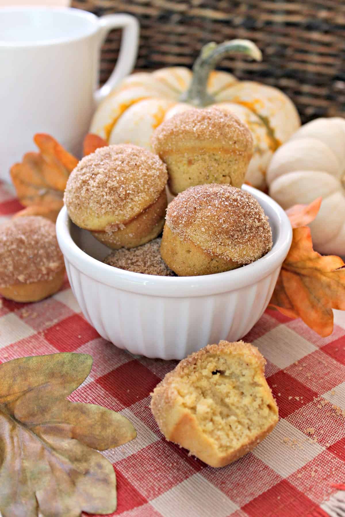 Mini Pumpkin Spice Donut Muffins! These petite pumpkin spice muffins imitate a breakfast favorite with a sugar and spice-encrusted dome. All of the flavors of fall rolled up into a tasty breakfast or brunch treat! 