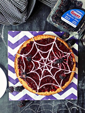 "Spider Web" Blackberry Dessert Pizza! Looking for a sweet, spooky snack with a little less sugar? This creepy-crawly dessert is honey-sweetened & topped with fresh blackberries for a treat without the sugar rush!