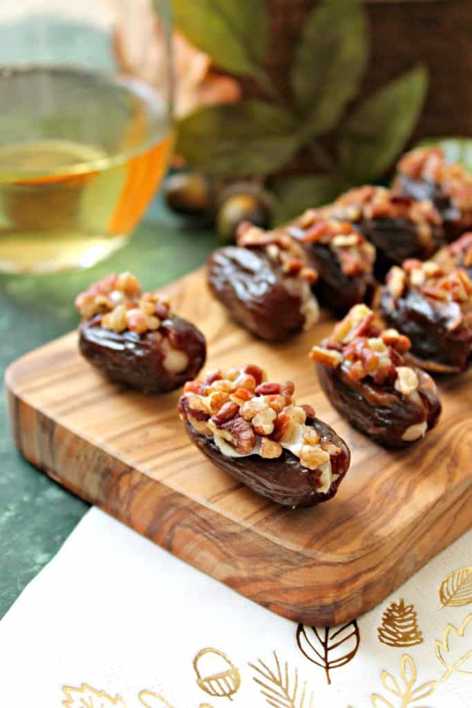 Honey-Cinnamon Cream Cheese Stuffed Dates! Sweet, sticky dates are stuffed full of honey-sweetened, cinnamon-spiced cream cheese, then rolled in crunchy roasted pecans. A perfect snack or appetizer to prepare last minute holiday entertaining!