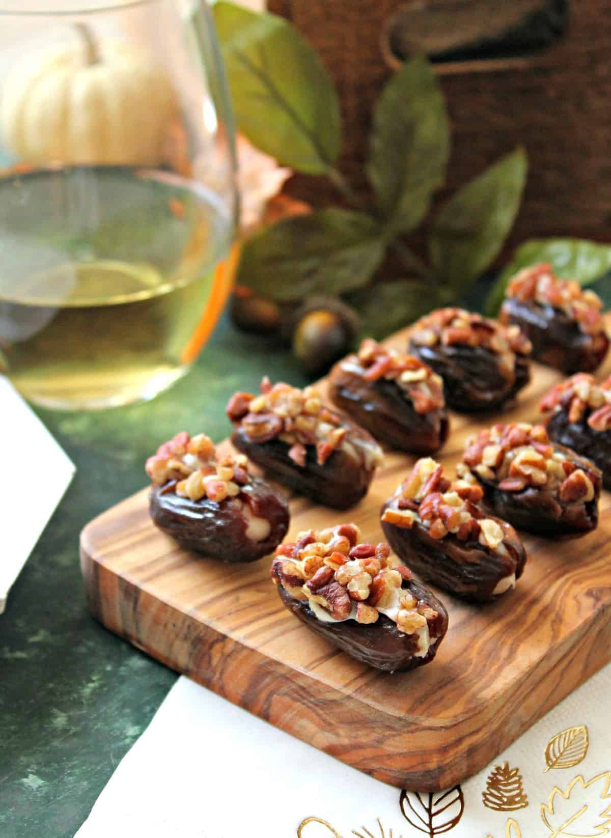 Honey-Cinnamon Cream Cheese Stuffed Dates! Sweet, sticky dates are stuffed full of honey-sweetened, cinnamon-spiced cream cheese, then rolled in crunchy roasted pecans. A perfect snack or appetizer to prepare last minute holiday entertaining! 