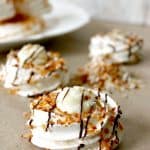 Toasted Coconut Mini Pavlovas with Coconut Custard! Crisp meringue nests house a creamy coconut custard filling in these beautiful treats.