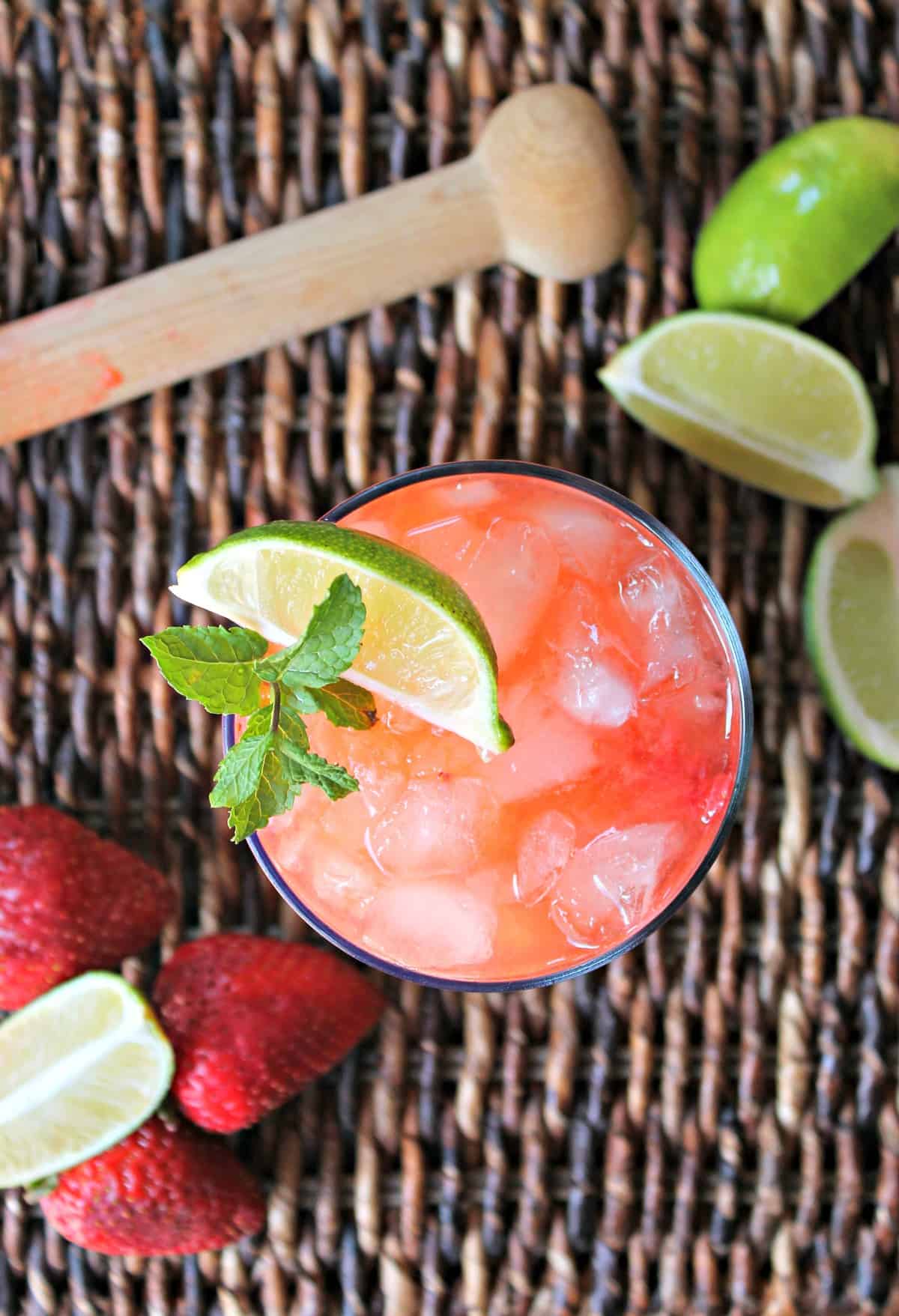 Strawberry Mojitos! Sweet and refreshing, these cocktails are a great addition to summer menus! The flavors of fresh strawberries, lime and mint come together to create a berry-infused version of a delicious classic.