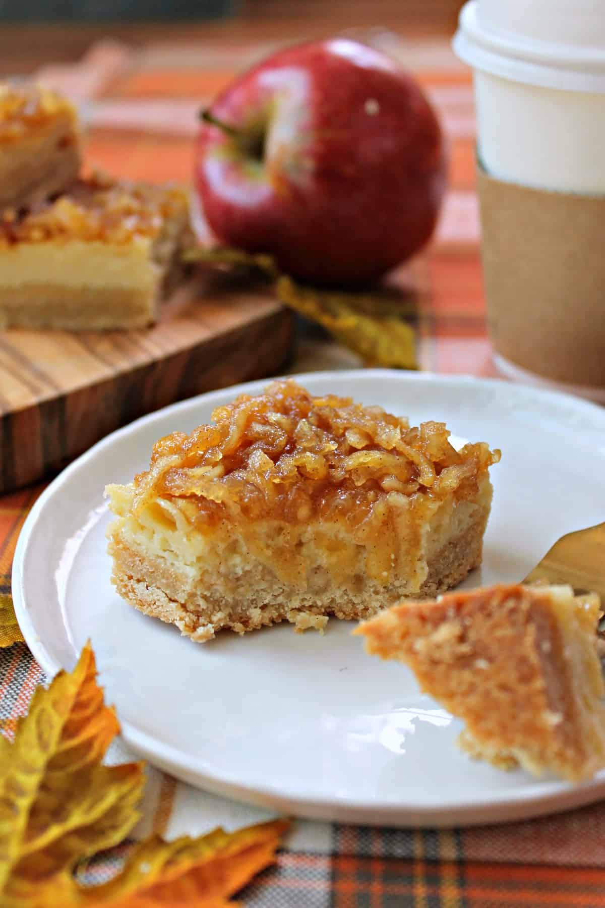 Apple Custard Bars! The autumnal answer to lemon bars, these Apple Custard bars consist of sweet and creamy apple cider-infused custard atop a brown sugar shortcrust, then smothered in a spiced apple topping. 