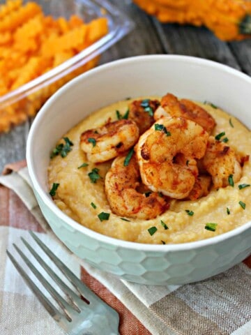Butternut Squash Shrimp & Grits! Flavorful shrimp are served atop creamy, cheesy butternut squash-infused grits. Down home & hearty with a seasonal twist, this dish is just what you'll crave on chilly days!