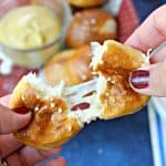 Easy Cheese-Stuffed Pretzel Bites! Store-bought pizza dough shaves precious prep time off of this deliciously simple pretzel bites recipe! Stuffed with gooey cheese, they're perfect for game day snacking! 
