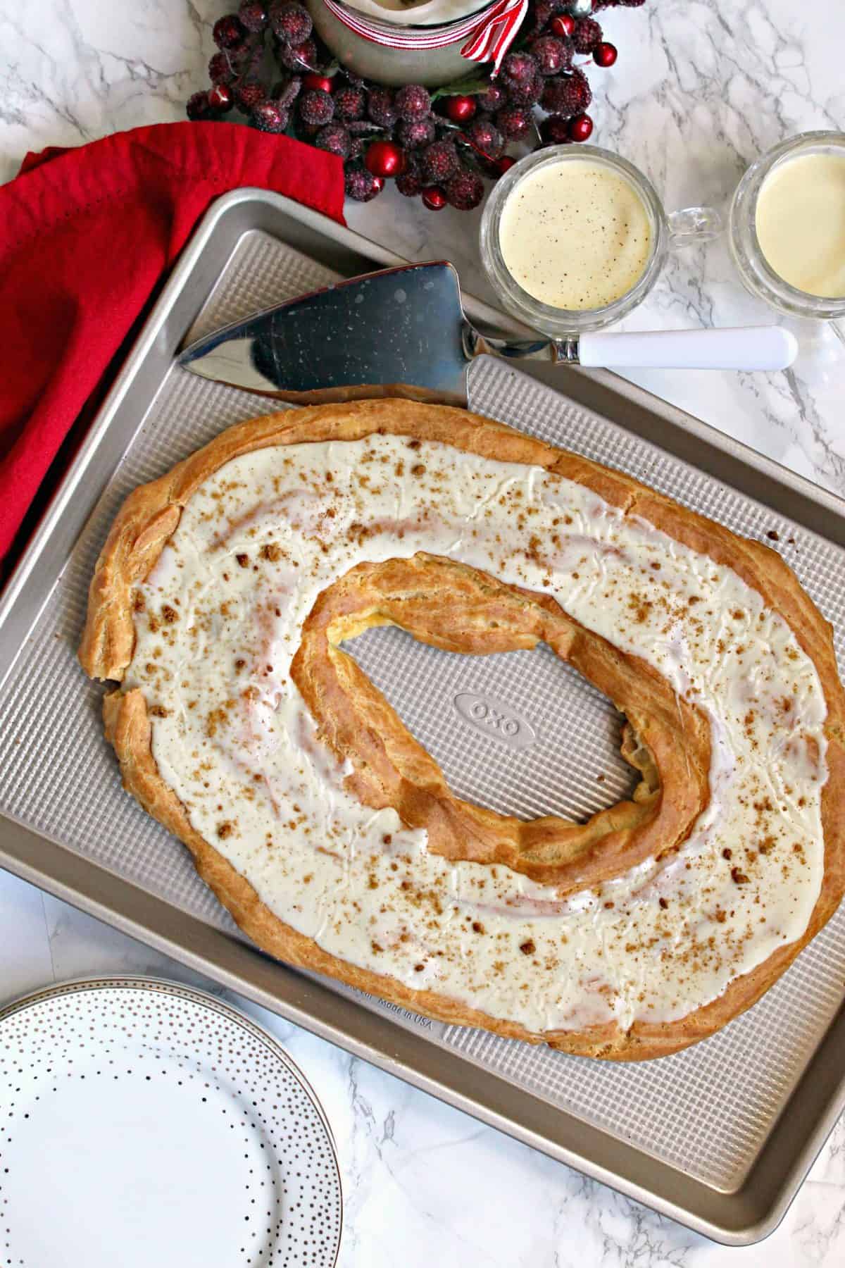 Eggnog Danish Kringle! The flavors of a favorite winter beverage shine though in this tender, glaze-covered treat that can be served for breakfast or dessert. This less labor-intensive version of the mouthwatering Danish pastry will become a holiday treat to treasure! 