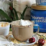 Coconut Latte on a saucer with holiday decor surrounding it.