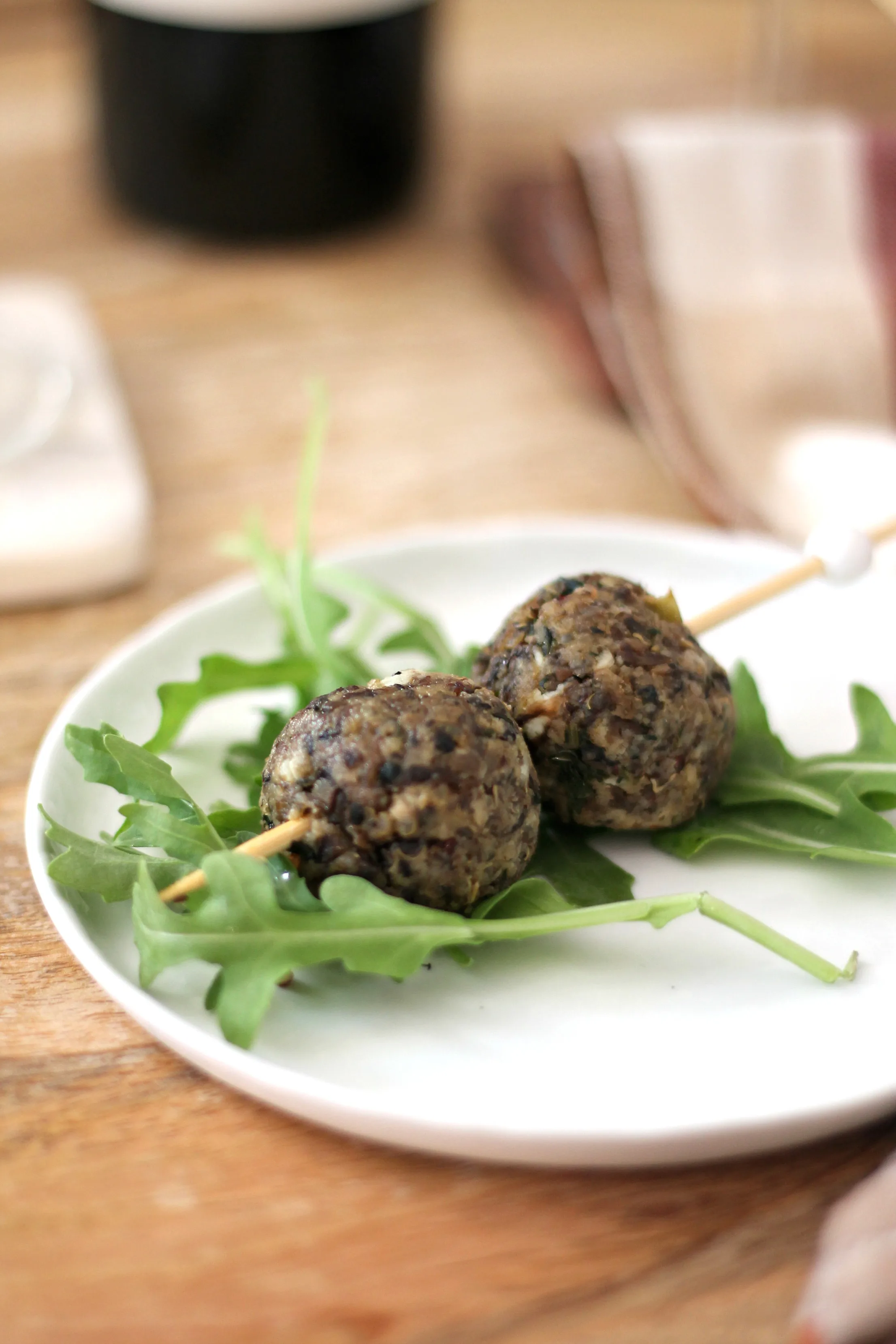 Closeup of vegetarian meatballs on white plate.