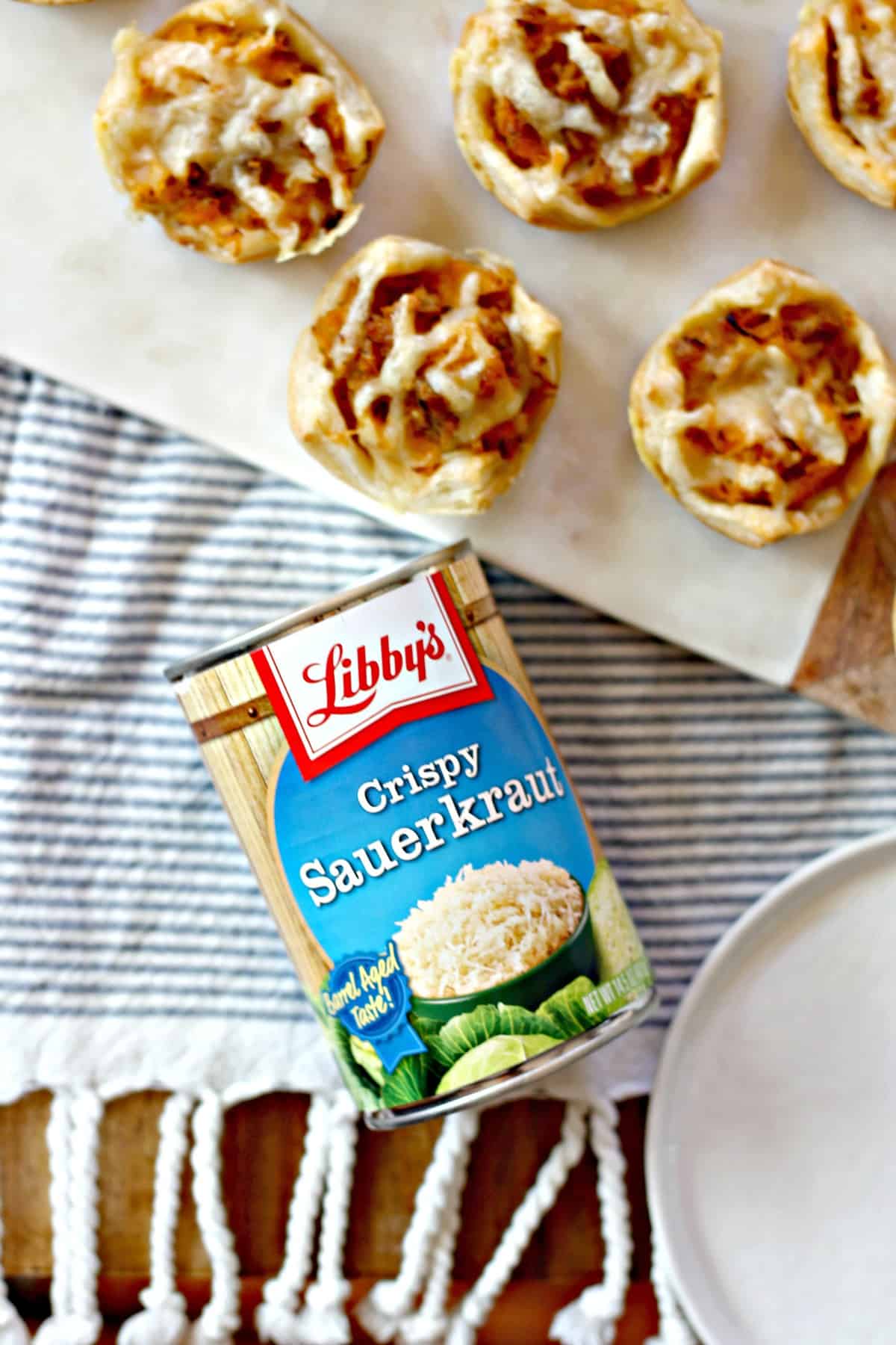 Overhead shot of a can of Libby's Crispy Sauerkraut next to Sausage Reuben Puffs.