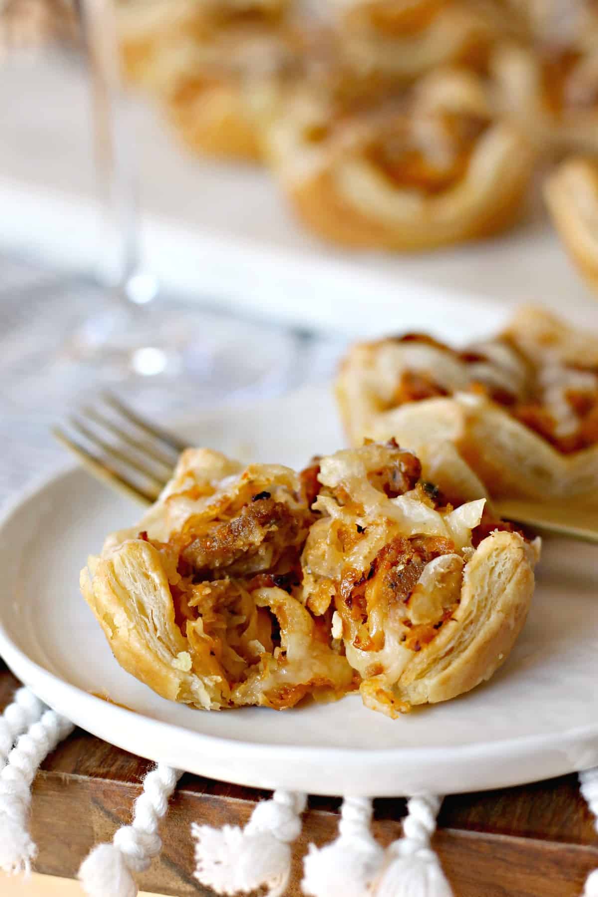 Close up of halved Sausage Reuben Puff.