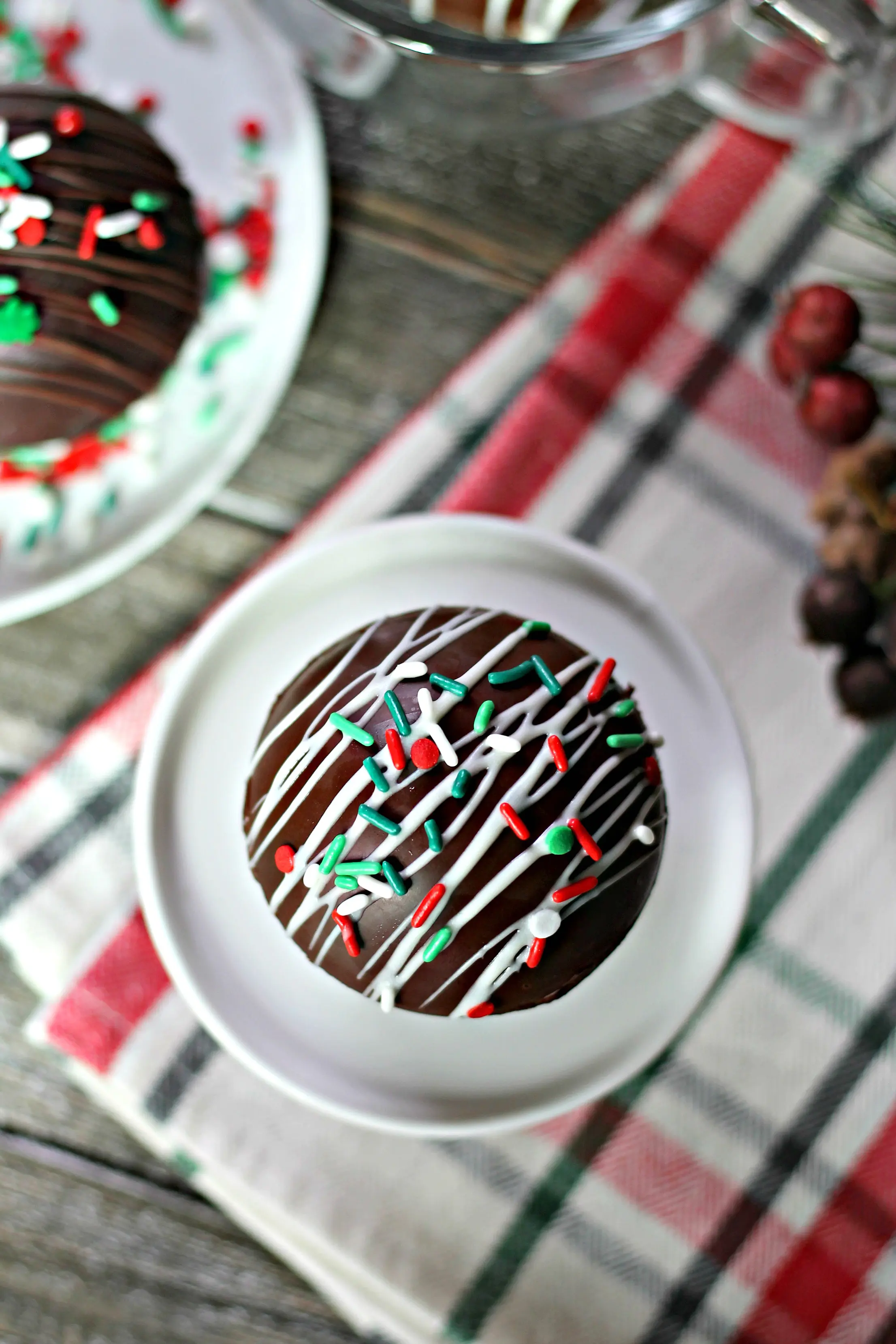 Overhead shot of homemade hot chocolate bomb with holiday sprinkles.