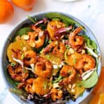 Overhead shot of Asian-Inspired Orange Salad with Shrimp with oranges next to it.